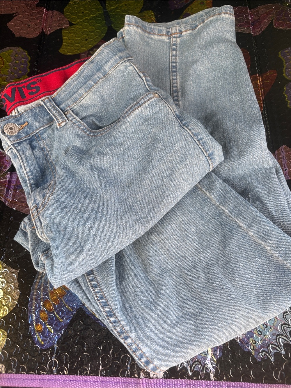 Levi's Light Blue Relaxed Men’s Jeans with Red Waistband Accent
